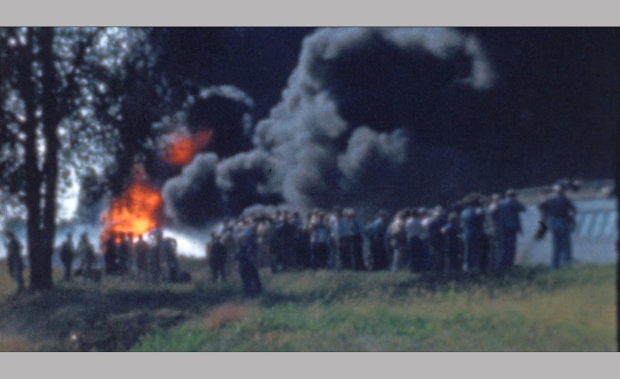 smoke rises from burning oil from the freight train