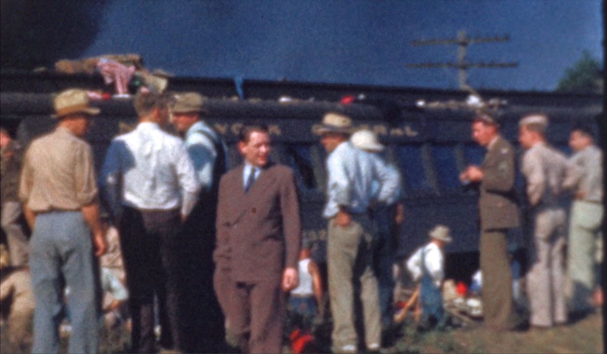 soldiers sort through baggage next to a tattered train baggage car