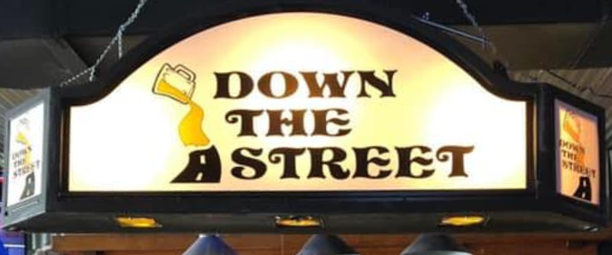 the business sign over the bar at Down the Street